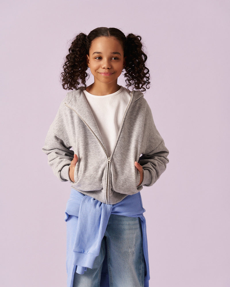 Girl in the ON7 melange zip hoodie over a white tee