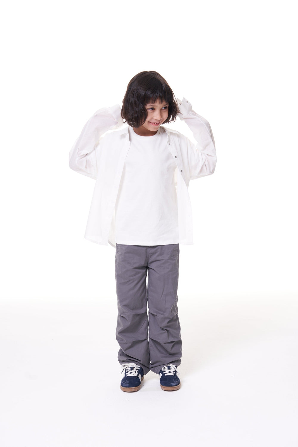 Girl in the ON7 Shirt in off white, worn open over a white tee