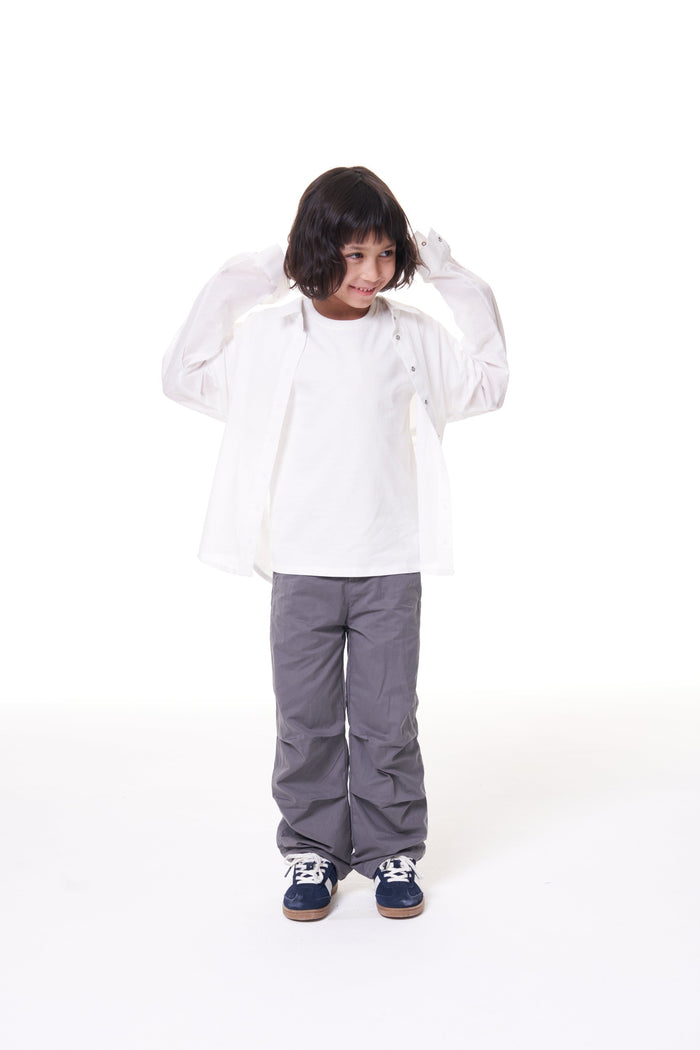 Girl in the ON7 Shirt in off white, worn open over a white tee