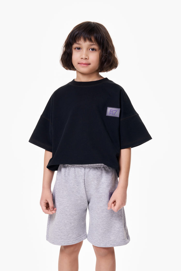 Boy wearing the ON7 Everyday Shorts in melange, front view