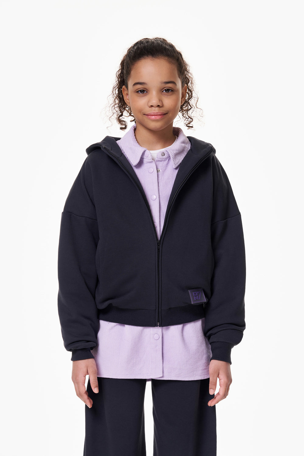 Girl wearing the ON7 Zip Hoodie in graphite, view 4 of 5
